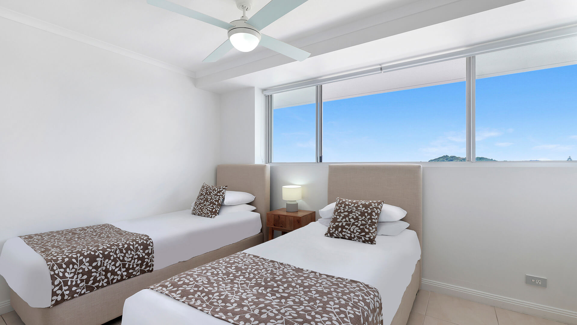 Twin bedroom in the Standard 2 Bedroom Ocean View Apartment at ULTIQA Points North, with natural light and mountain views.