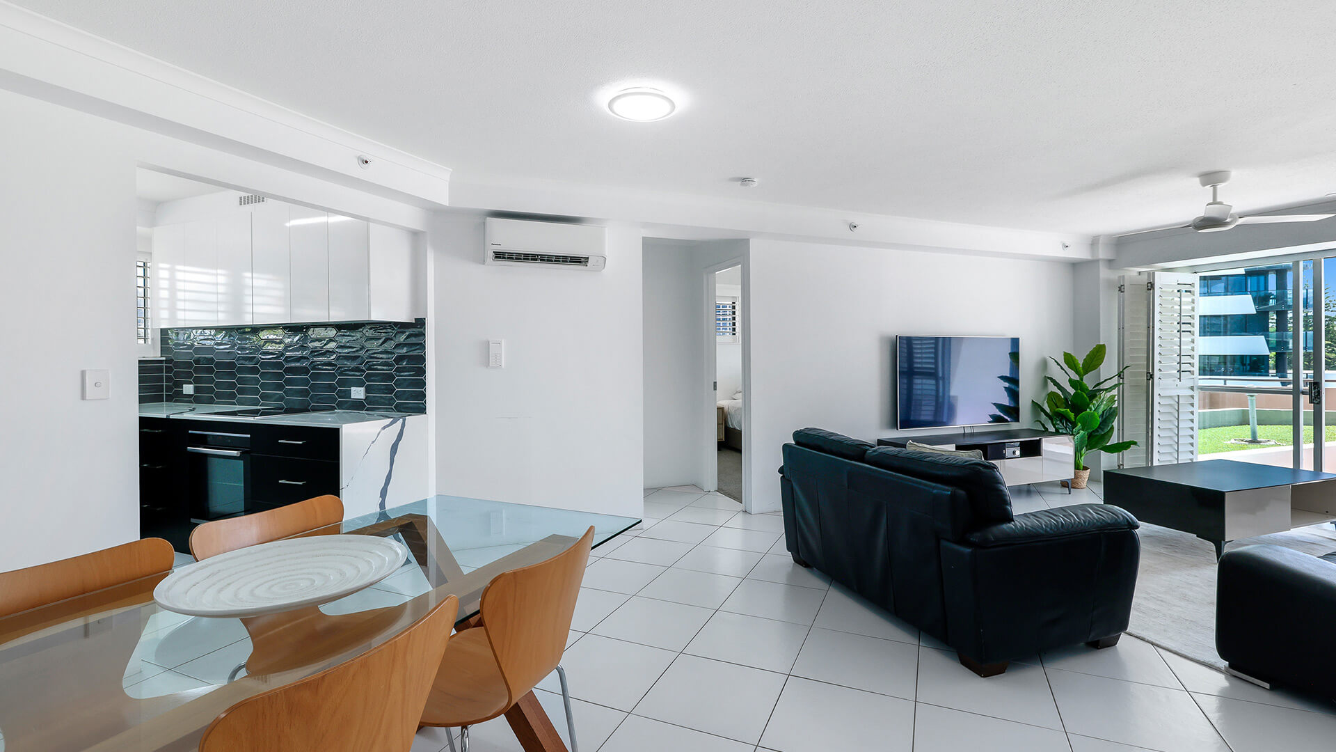 Dining and living area in the Superior 2 Bedroom Courtyard Apartment at ULTIQA Points North, featuring modern finishes and courtyard access.