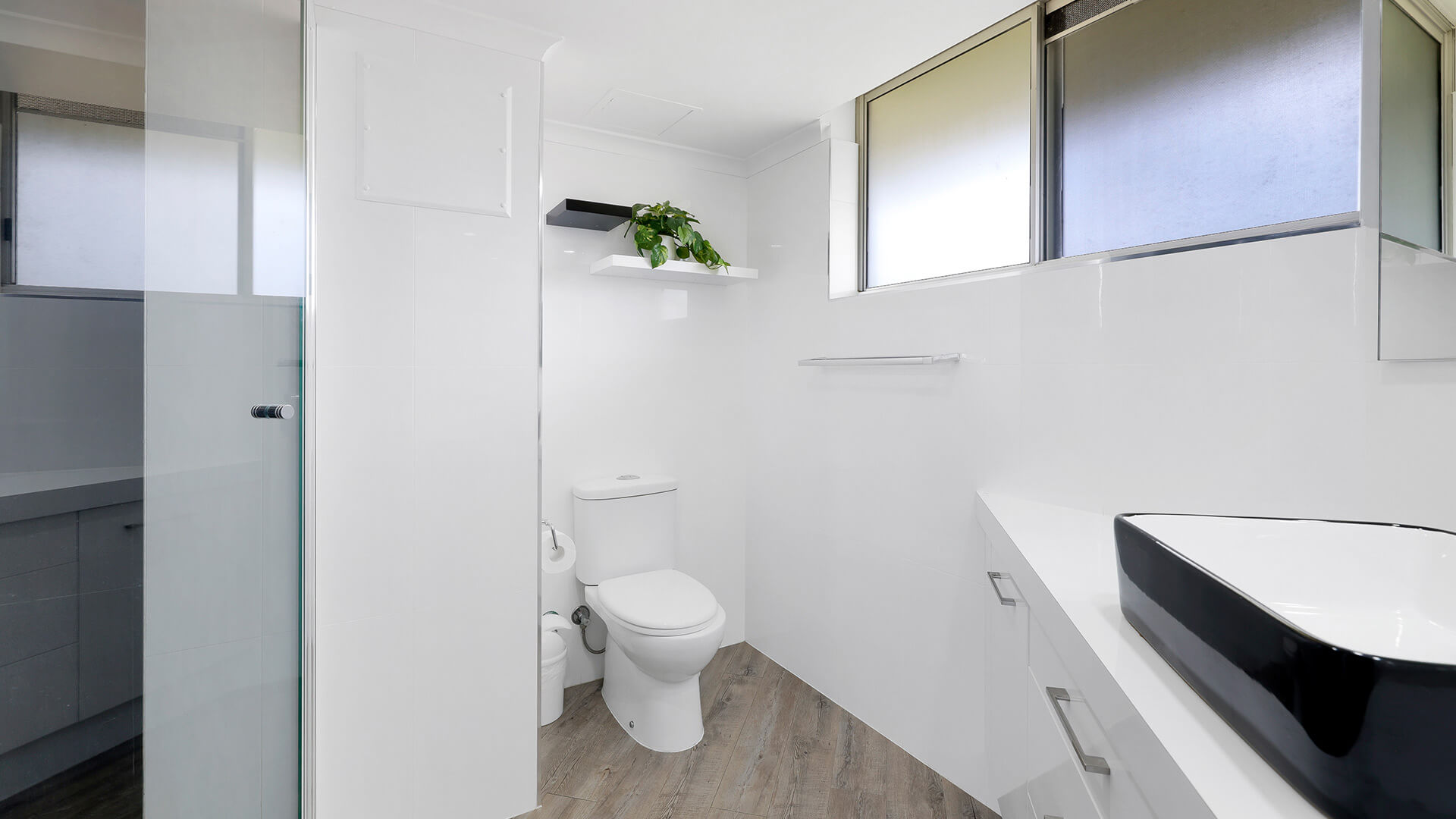 Modern bathroom in the Superior 2 Bedroom Courtyard Apartment at ULTIQA Points North, featuring a walk-in shower and contemporary vanity.