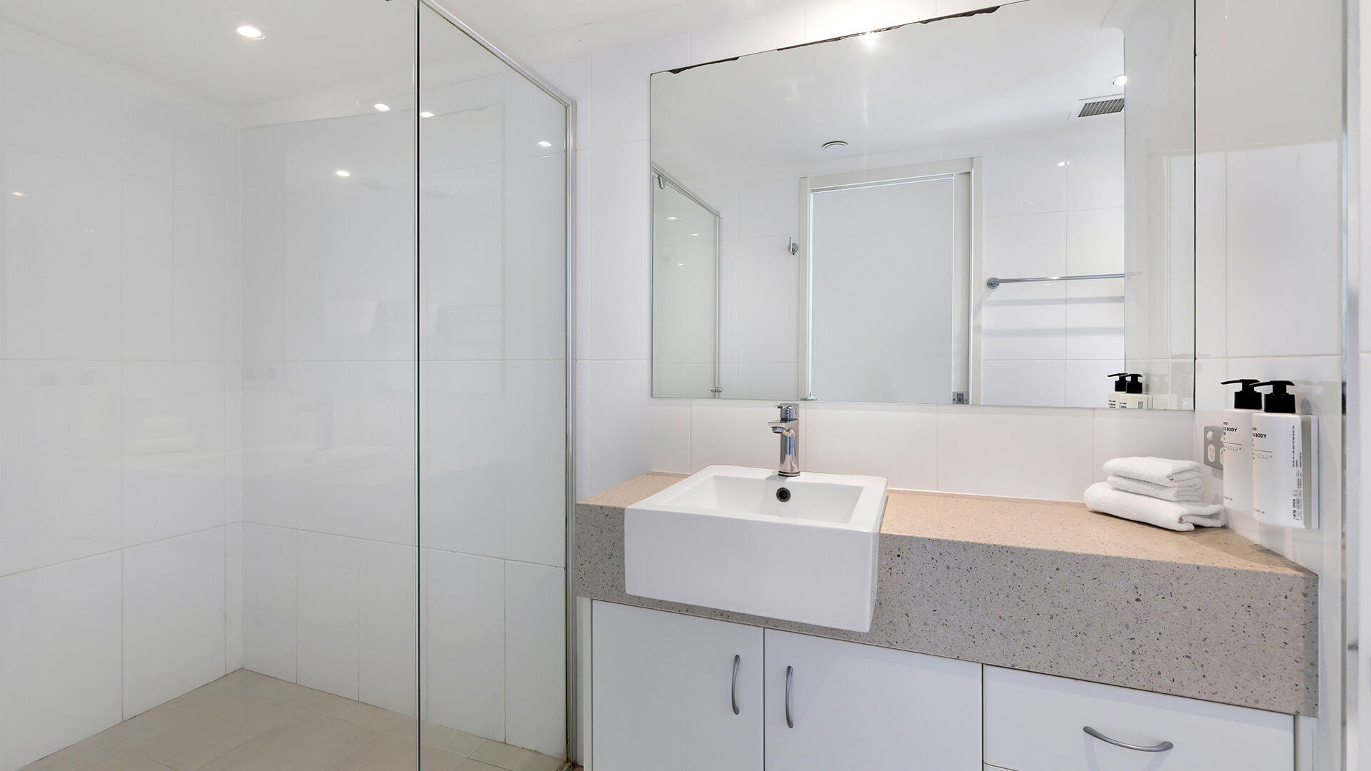 Spacious modern bathroom with walk-in shower in the Deluxe 2 Bedroom Centre Front Apartment at ULTIQA Points North.