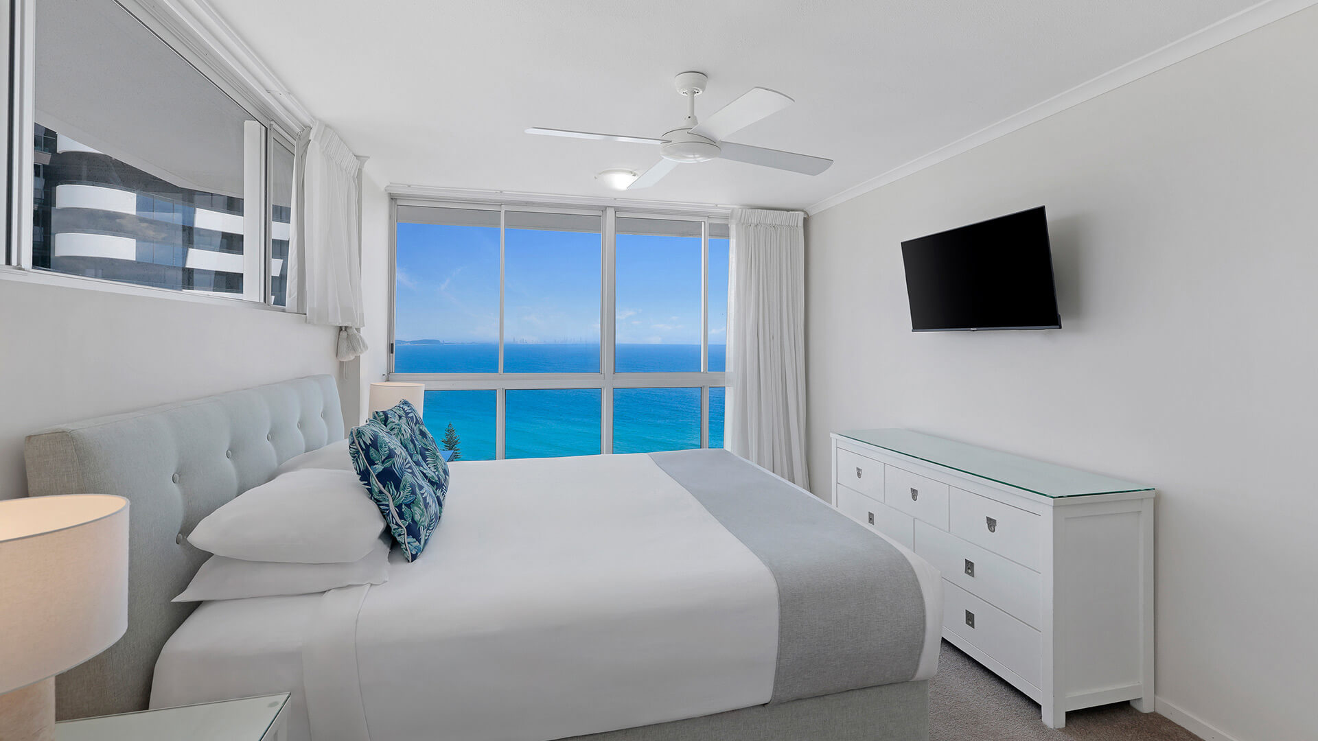 Bright master bedroom in the Superior 3 Bedroom Ocean View Apartment featuring queen bed, soft coastal décor and sweeping ocean views.