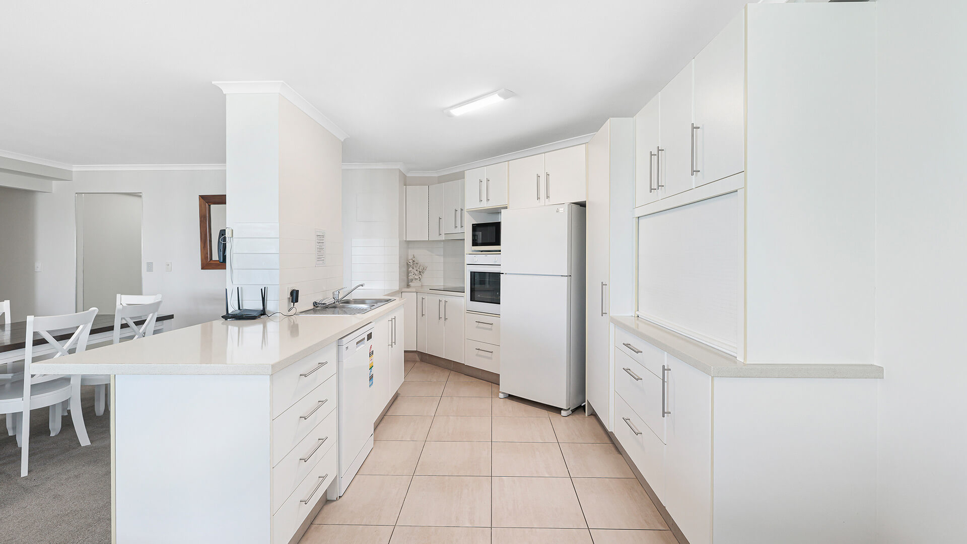 Modern spacious kitchen and dining area in the Superior 1 Bedroom Ocean View Apartment at ULTIQA Points North.