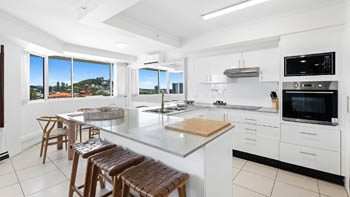 Modern kitchen and dining area in the 2 Bedroom Pool View Apartment at ULTIQA Points North with large windows and natural light.