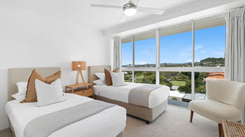 Twin bedroom in the 2 Bedroom Pool View Apartment at ULTIQA Points North with large windows and scenic views.