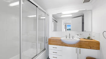 Bathroom in the 2 Bedroom Pool View Apartment at ULTIQA Points North with shower over bath and modern vanity.