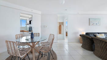 Dining area in the Standard 2 Bedroom Ocean View Apartment at ULTIQA Points North, with access to the kitchen and bedrooms.