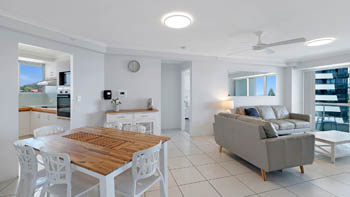 Open-plan living and dining area in the Standard 2 Bedroom Centre Front Apartment at ULTIQA Points North, with access to the balcony.