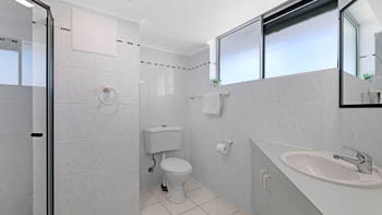 Bathroom in the Standard 2 Bedroom Centre Front Apartment at ULTIQA Points North, featuring a shower and vanity.