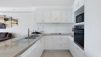 Modern kitchen in the Deluxe 2 Bedroom Centre Front Apartment at ULTIQA Points North with full appliances.