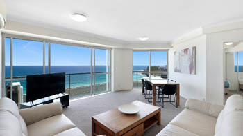 Bright oceanfront living and dining area in the Deluxe 2 Bedroom Centre Front Apartment at ULTIQA Points North.