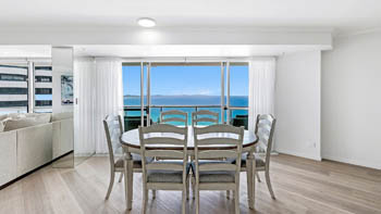 Dining area with ocean views in the Deluxe 3 Bedroom Ocean View Apartment at ULTIQA Points North Coolangatta.