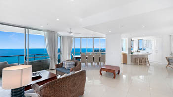 Open-plan living, dining, and kitchen area of the 4 Bedroom Oceanfront Penthouse at ULTIQA Points North with sweeping ocean views.