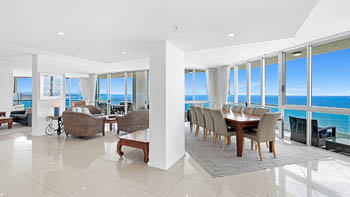 Spacious open-plan living and dining area of the 4 Bedroom Oceanfront Penthouse at ULTIQA Points North with panoramic ocean views.