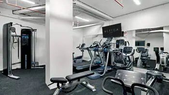 Fully equipped fitness centre at ULTIQA Beach Haven on Broadbeach featuring treadmills, cross trainers, weights and cardio machines for guest use.