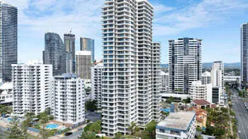Aerial view of ULTIQA Beach Haven on Broadbeach surrounded by high-rise buildings, with resort pools visible and just moments from the Gold Coast beachfront.