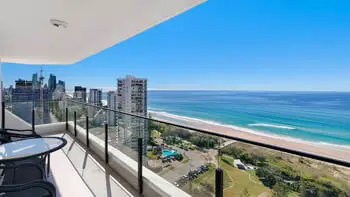 Private balcony with panoramic Gold Coast skyline and beach views complete with outdoor table and chairs.