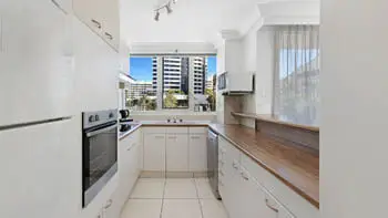 Fully equipped kitchen with modern appliances and city views in the 2 Bedroom Apartment at ULTIQA Beach Haven on Broadbeach.