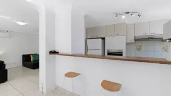 Kitchen breakfast bar with two stools in the 2 Bedroom Apartment at ULTIQA Beach Haven on Broadbeach.