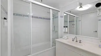 Second bathroom with shower-over-bath and vanity in the 2 Bedroom Apartment at ULTIQA Beach Haven on Broadbeach.