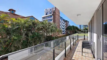 Private balcony with outdoor seating and leafy garden views in the 2 Bedroom Apartment at ULTIQA Beach Haven on Broadbeach.