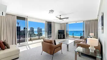 Spacious living room in the 2 Bedroom Ocean View Apartment at ULTIQA Beach Haven on Broadbeach with floor-to-ceiling windows and sweeping ocean views.