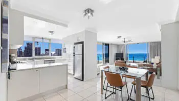 Open-plan kitchen, dining, and living area in the 2 Bedroom Ocean View Apartment at ULTIQA Beach Haven on Broadbeach with full-length ocean views.