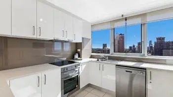 Modern kitchen in the 2 Bedroom Ocean View Apartment at ULTIQA Beach Haven on Broadbeach with stainless steel appliances and city views.