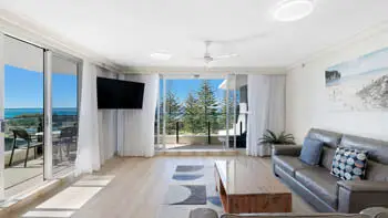 Living room in 2 Bedroom Ocean View Apartment at ULTIQA Beach Haven on Broadbeach with balcony, ocean views, and modern furnishings.