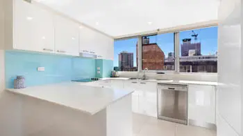Fully equipped kitchen in the 2 Bedroom Ocean View Apartment at ULTIQA Beach Haven on Broadbeach with modern appliances and city views.