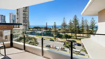 Private balcony of the 2 Bedroom Ocean View Apartment at ULTIQA Beach Haven on Broadbeach overlooking the parklands and Pacific Ocean.