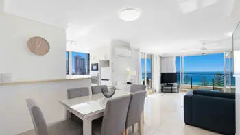 Dining and lounge area with ocean views in the Standard 2 Bedroom Ocean View Apartment at ULTIQA Beach Haven on Broadbeach.