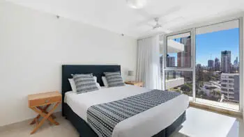 Main bedroom with city views in the Standard 2 Bedroom Ocean View Apartment at ULTIQA Beach Haven on Broadbeach.
