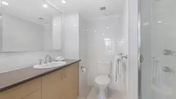 Main bathroom with walk-in shower, vanity, and toilet in the Standard 2 Bedroom Ocean View Apartment at ULTIQA Beach Haven on Broadbeach.