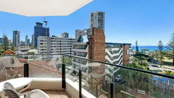 Private balcony in the Standard 2 Bedroom Ocean View Apartment at ULTIQA Beach Haven on Broadbeach, offering city skyline views and glimpses of the ocean.