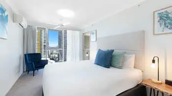 Master bedroom in the Premium 2 Bedroom Ocean View Apartment at ULTIQA Beach Haven on Broadbeach with city views and king bed.
