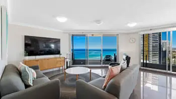Bright and spacious living area in the Premium 2 Bedroom Ocean View Apartment at ULTIQA Beach Haven on Broadbeach with ocean views and access to a private balcony.