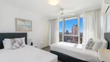 Second bedroom with twin beds and natural light at ULTIQA Beach Haven on Broadbeach, family-friendly Gold Coast stay.