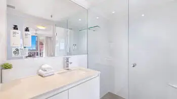 Contemporary bathroom with walk-in shower at ULTIQA Beach Haven on Broadbeach, Surfers Paradise apartment.