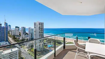 Balcony dining setting with panoramic coastline views at ULTIQA Beach Haven on Broadbeach, Surfers Paradise.