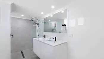 Modern bathroom with double vanity and walk-in shower at ULTIQA Beach Haven on Broadbeach, Surfers Paradise apartment.