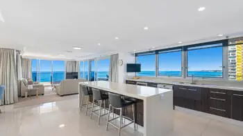 Open-plan kitchen and lounge with ocean views in the Sub Penthouse at ULTIQA Beach Haven on Broadbeach.