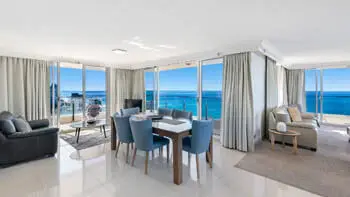 Open-plan kitchen and lounge with panoramic ocean views in the Sub Penthouse at ULTIQA Beach Haven on Broadbeach.