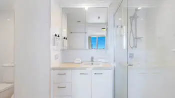 Bright ensuite in the Sub Penthouse at ULTIQA Beach Haven on Broadbeach, featuring a walk-in shower and large mirrored vanity.