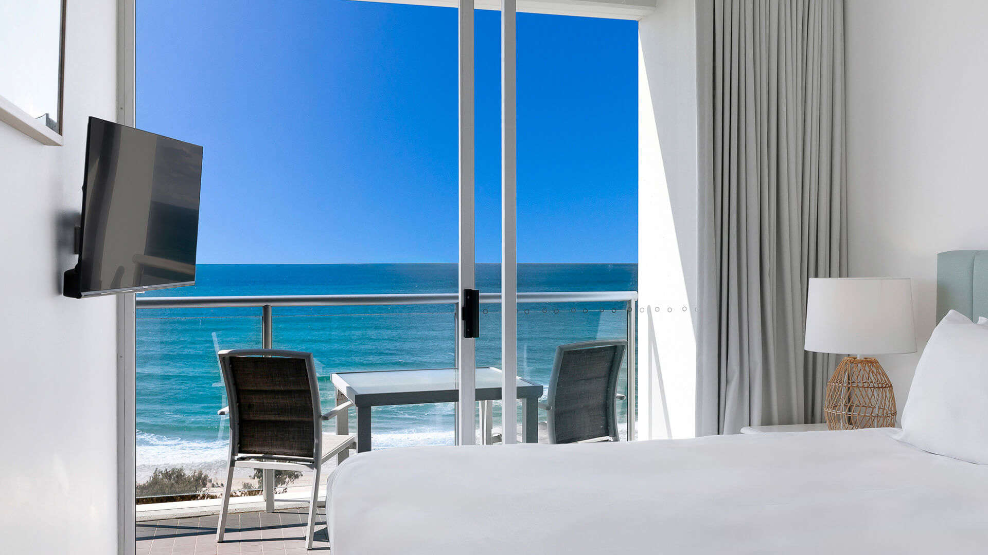 Bedroom with balcony seating and ocean views in 1 Bedroom Ocean View Apartment at ULTIQA Air on Broadbeach.