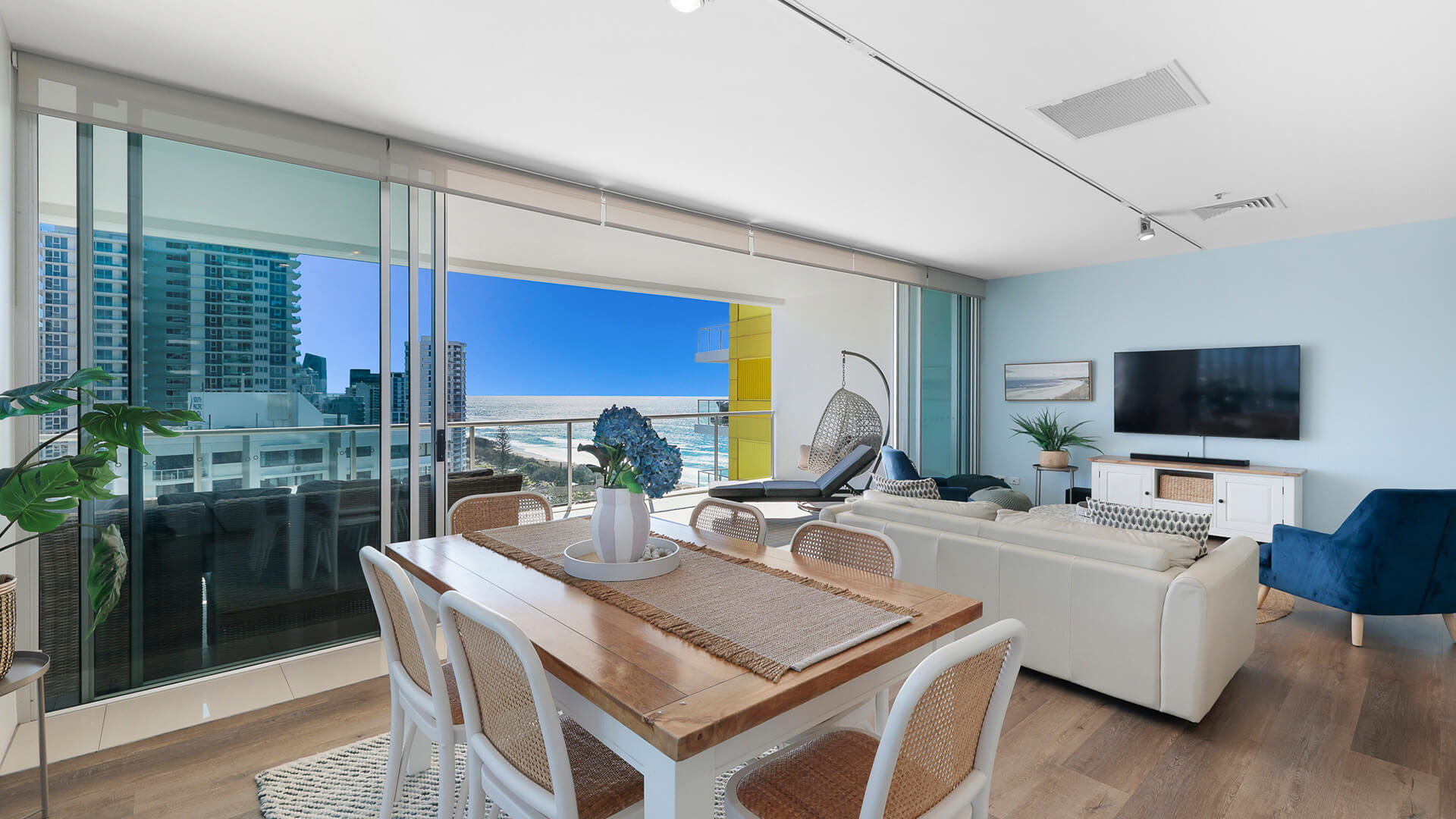 Spacious living and dining area with ocean and city views in 2 Bedroom Gold Coast View Suite at ULTIQA Air on Broadbeach.