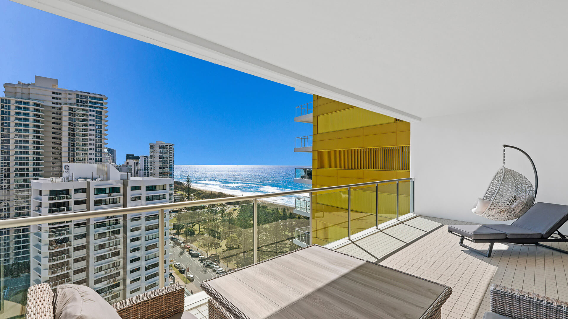 Private balcony with outdoor seating and ocean views from 2 Bedroom Gold Coast View Suite at ULTIQA Air on Broadbeach.