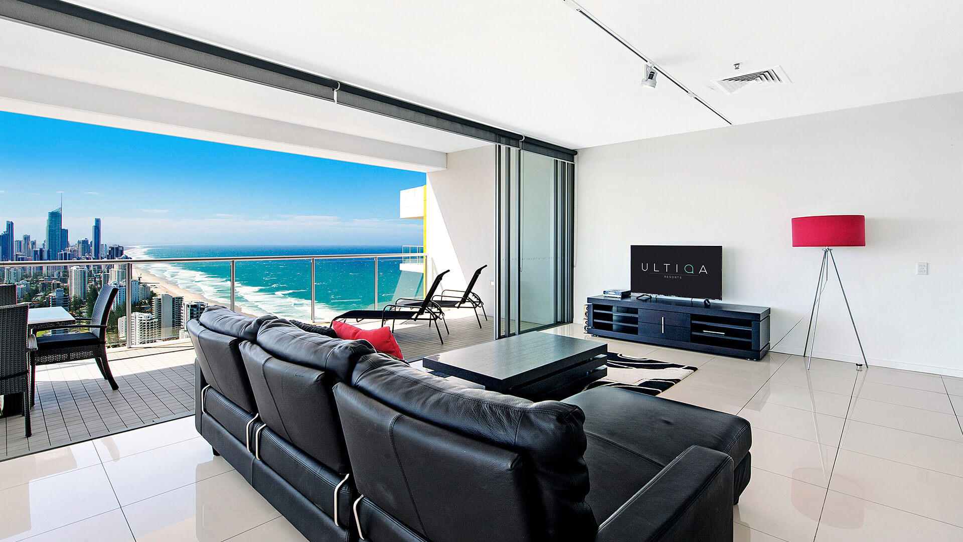 Spacious living area with balcony showcasing ocean and skyline views from 2 Bedroom Gold Coast View Suite at ULTIQA Air on Broadbeach.