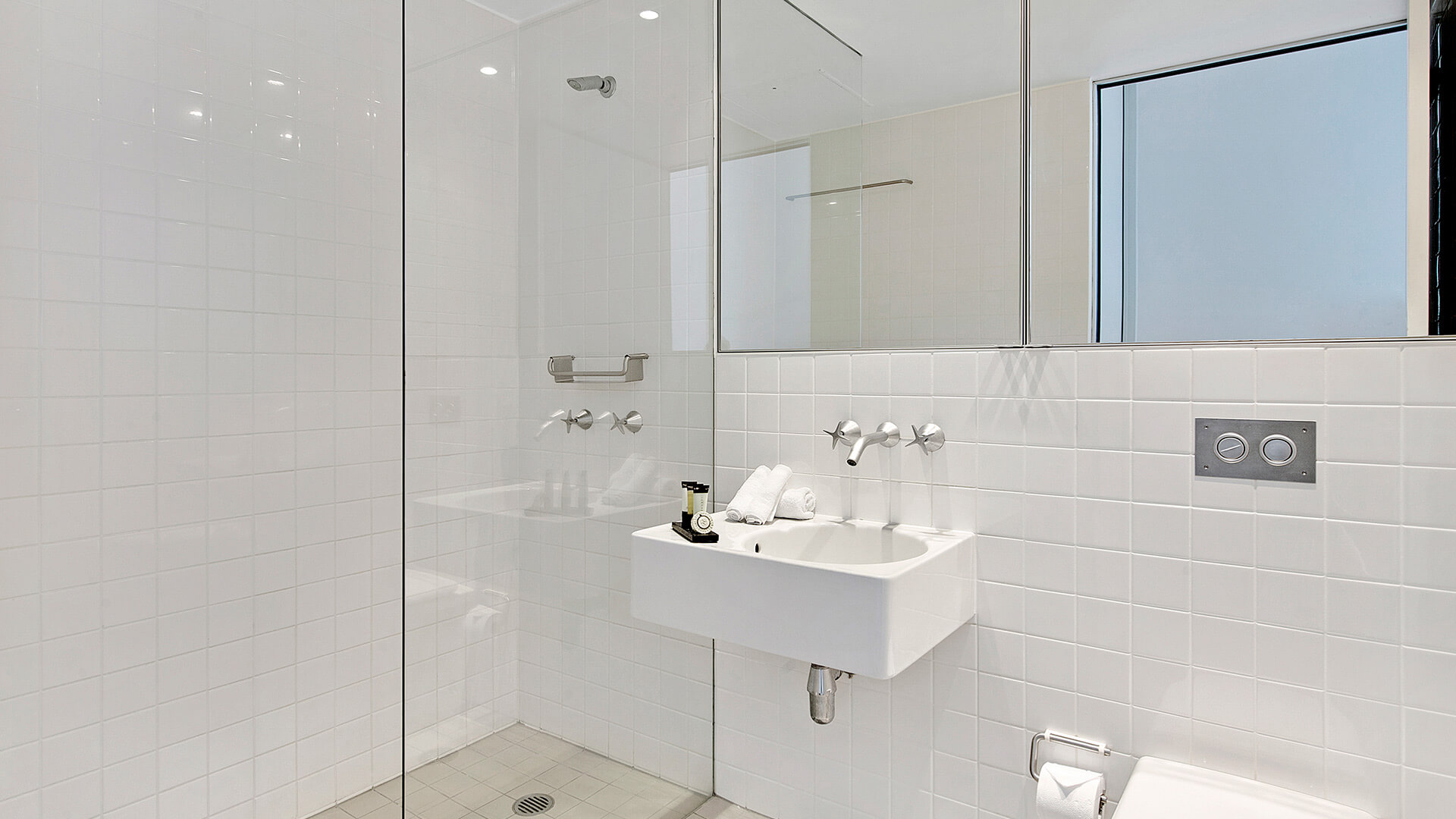 Modern bathroom with walk-in shower, vanity, and contemporary fittings in 2 Bedroom Ocean View Apartment at ULTIQA Air on Broadbeach.