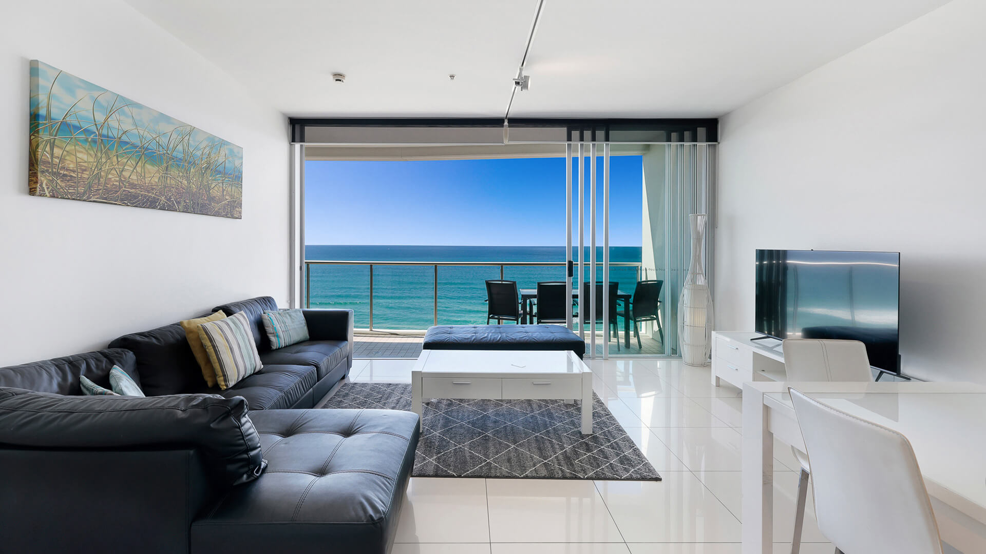 Living room with balcony and ocean views in 2 Bedroom Ocean View Apartment at ULTIQA Air on Broadbeach.