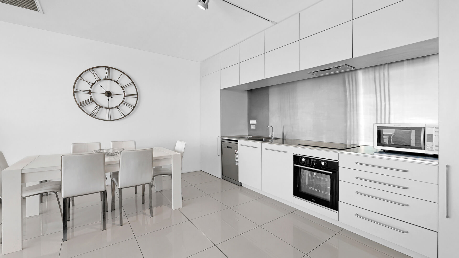 Spacious lounge and dining area with balcony views in 2 Bedroom Ocean View Apartment at ULTIQA Air on Broadbeach.